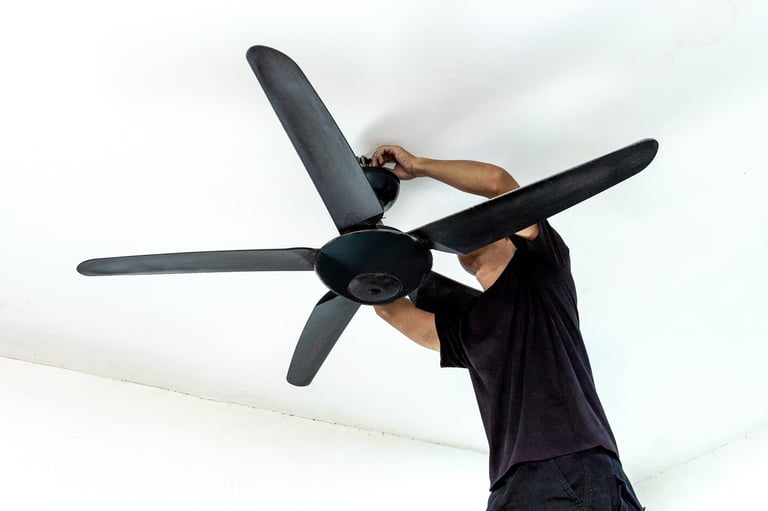Man installing a ceiling fan