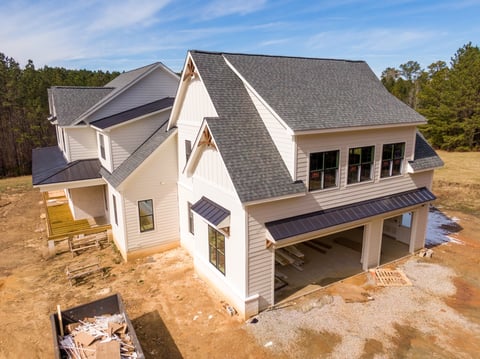 Custom home with combination asphalt shingles and standing seam metal roofing modern farmhouse style